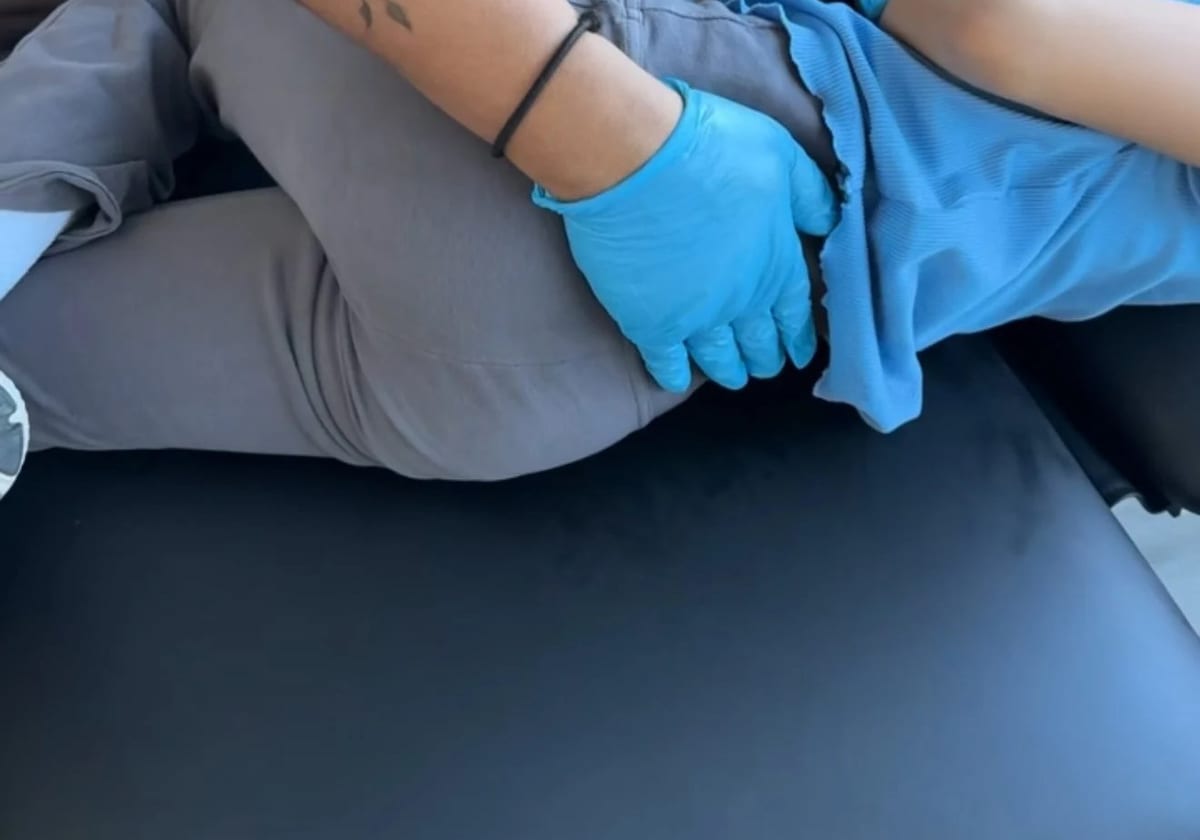 A clinician mobilising a patient's knee during a physiotherapy session